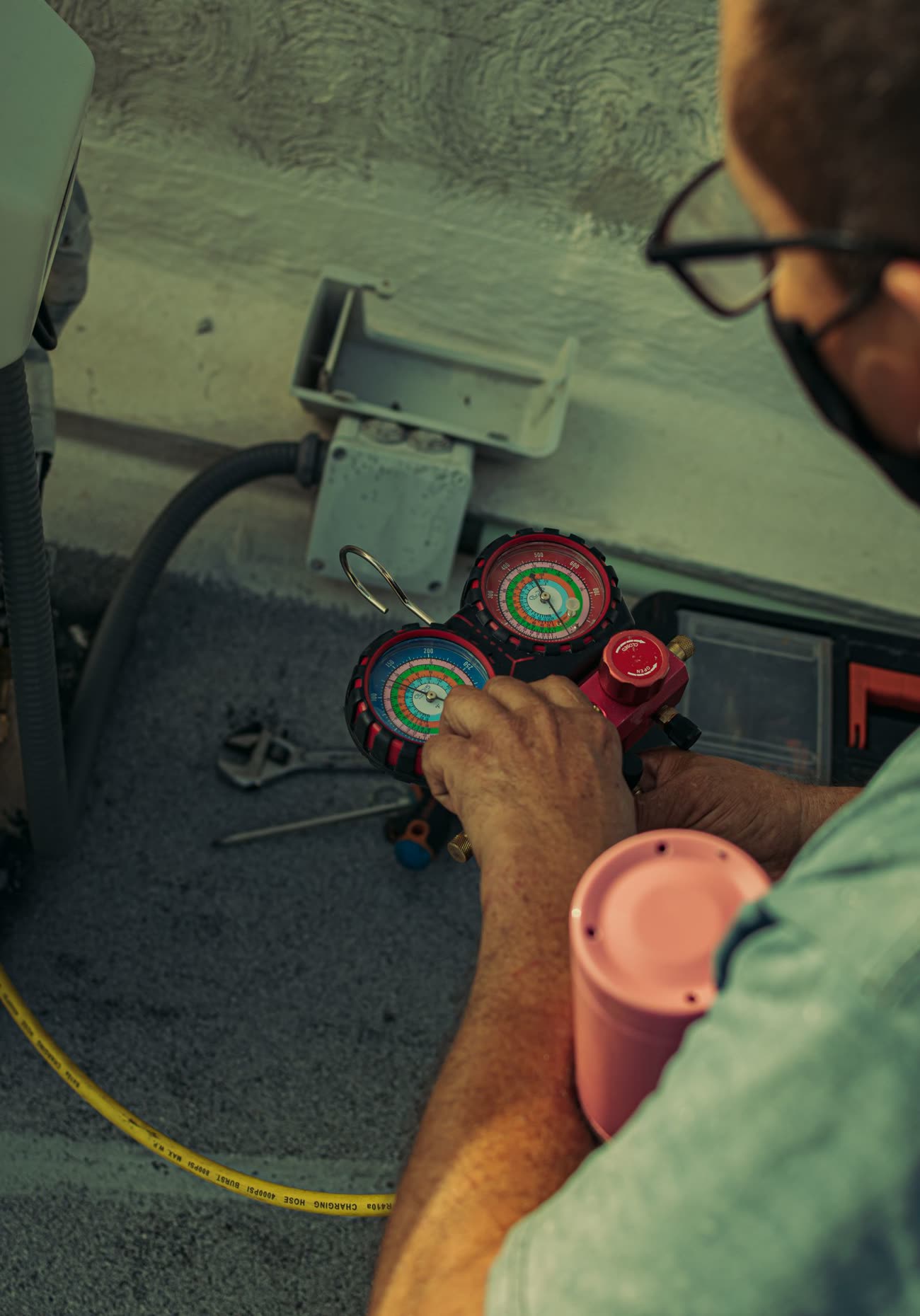 A technician repairing an AC unit